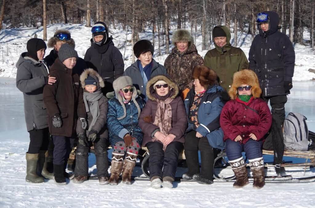 The Eveny community having an entertainment in taiga, on river ice.